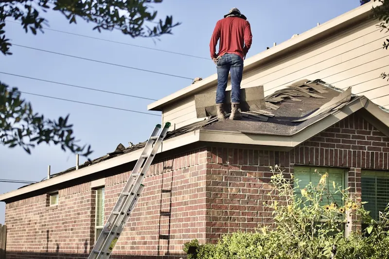 Professional roofer working on a residential roof in Oakfield